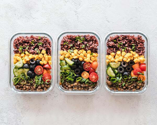 A person feeling relaxed and happy, knowing their meals for the week are ready.
